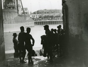 Teenage swimmers by the Thames at Tower Bridge. Image courtesy of the Tower Hamlets Local History Library and Archives.