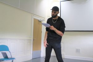 Rehearsal photo of spoken word artist Zohab for Boys will be boys.